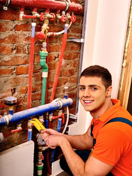 Men builder fixing heating system .