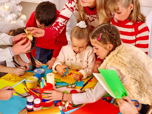 Children painting and cut sissors paper at art school.