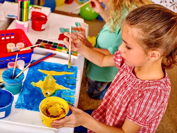 Group girl with brush painting in  kindergarten .