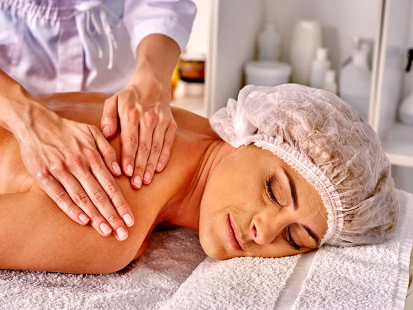 Woman take massage in spa salon