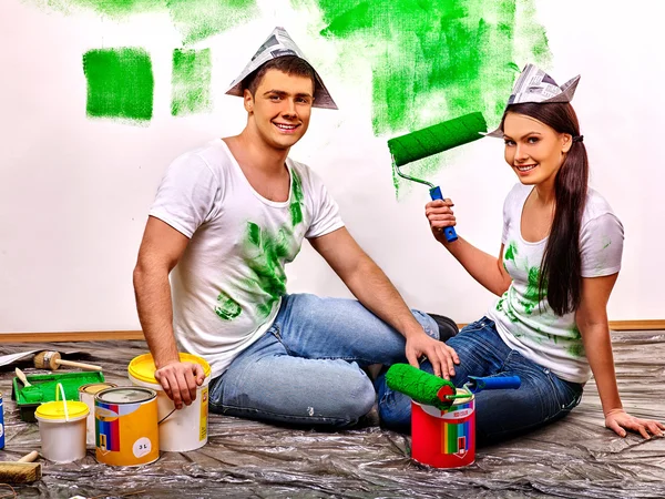 Family painting wall at home