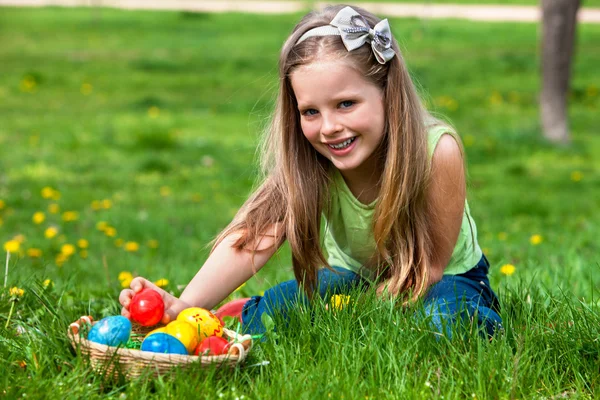 Child find easter egg outdoor.