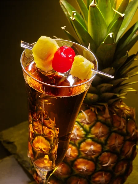 Champagne  cocktail with cherry and pineapple .