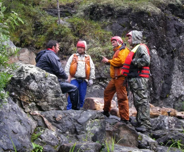 Men in protective helmets and life jackets