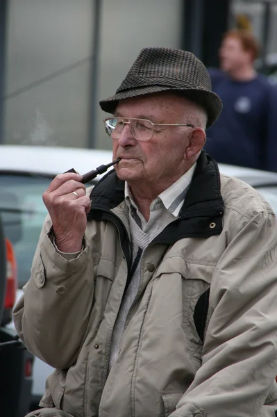 Old man smoking a tobacco pipe