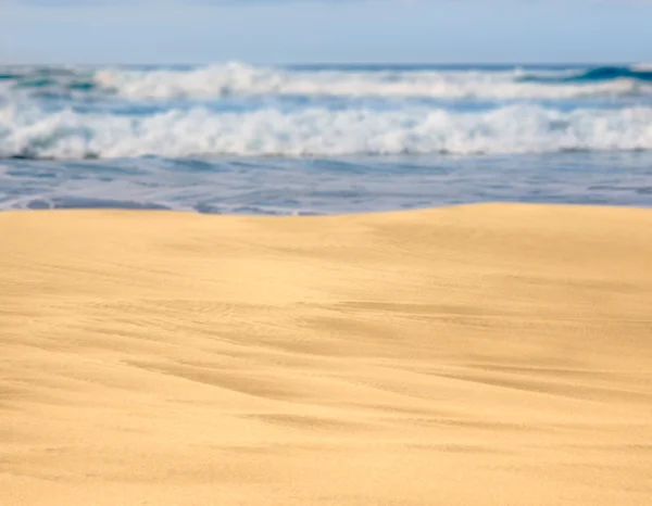 Sandy beach with waves in the distance