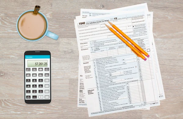 Coffee and calculator on 2015 IRS form 1040