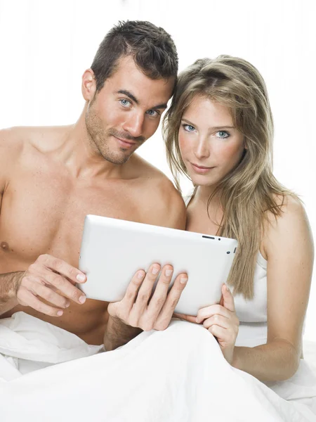 Attractive couple watching things in a tablet
