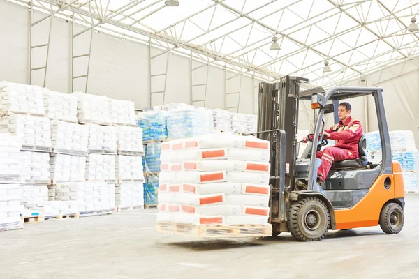 Forklift loader working in warehouse