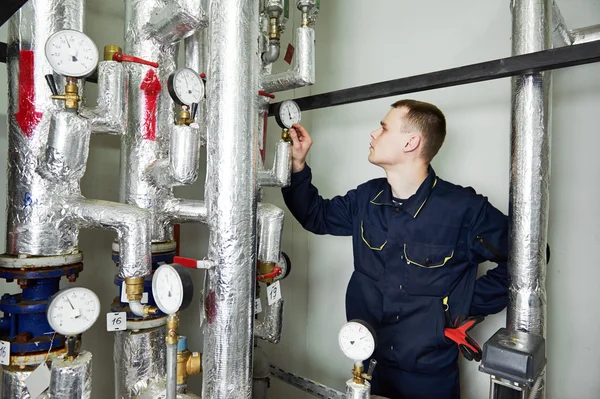 Heating engineer repairman in boiler room