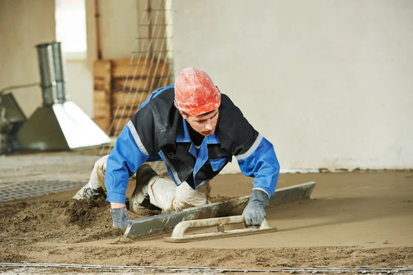 Plasterer concrete worker at floor work