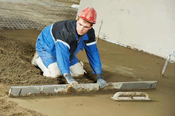 Plasterer concrete worker at floor work