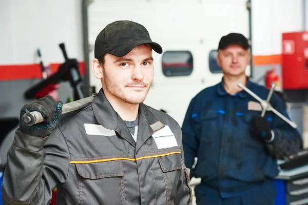 Two auto mechanic repairmans