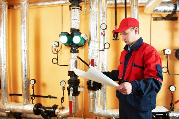 Heating engineer repairman in boiler room