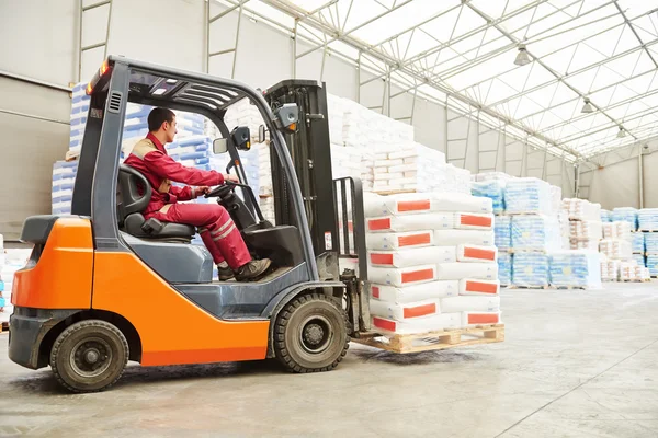 Forklift loader working in warehouse