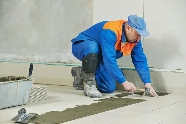 Tilers at industrial floor tiling renovation