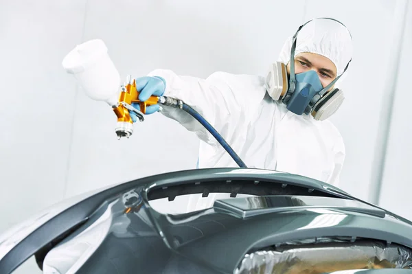 Worker painting auto car bumper