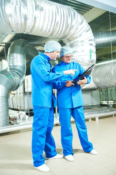 Pharmaceutical male workers in water preparation production line