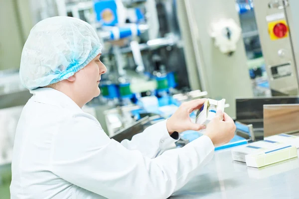 Pharmaceutical factory woman worker packing drugs