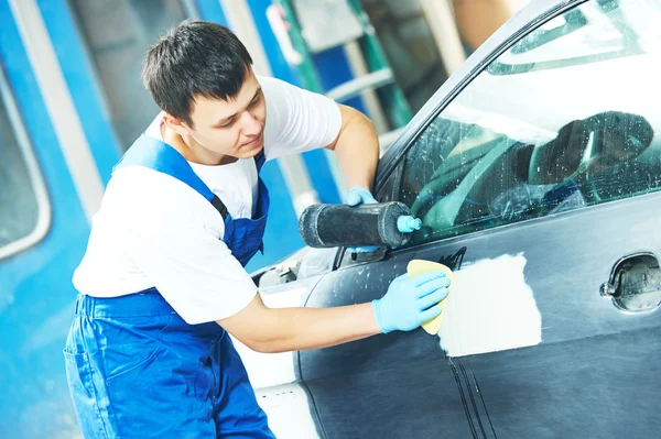 Worker applying car polish