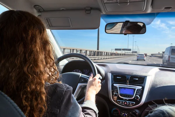 Woman driving vehicle on highway