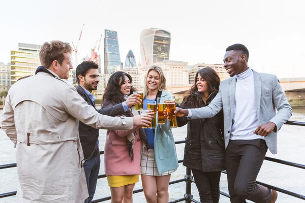 Business group drinking beer after work in London