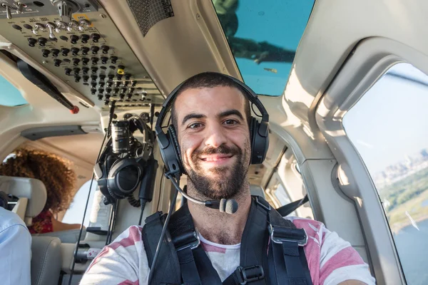 Young Man Taking Selfie in Helicopter Cabin While Flying