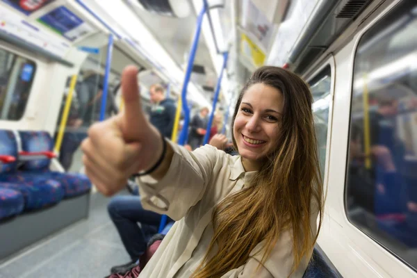 Happy Young Woman Commuting by Tube