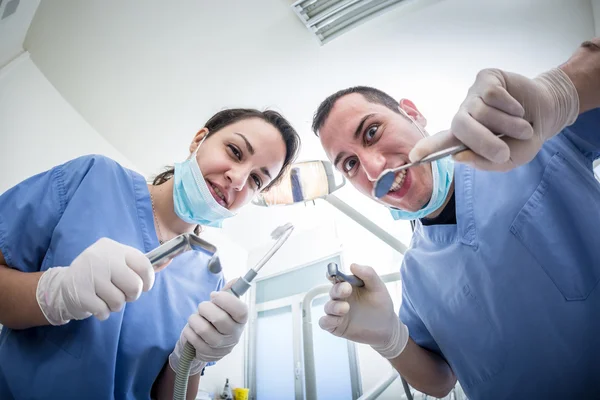 Dentists Holding Dental Tools Looking at Camera with Scary Faces