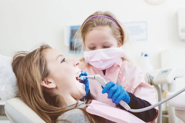 Little Girls Dentist and Patient During Dental Examination.