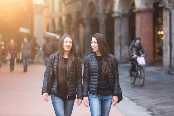Female Twins Walking on Inner City Street