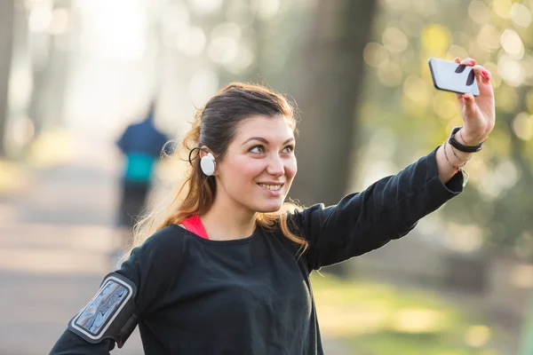 Young Sporty Woman Taking a Selfie at Park