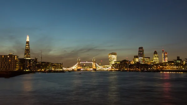 London skyline at dusk with River Thames on foreground