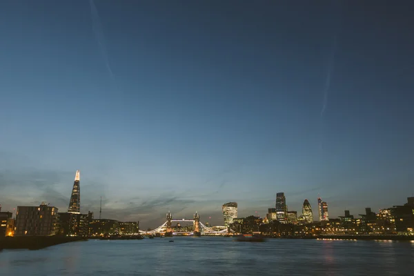 London skyline at dusk with River Thames on foreground