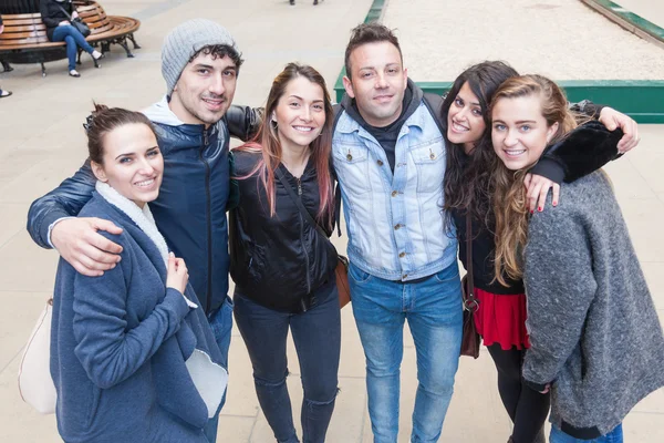 Group of friends embraced together in London.