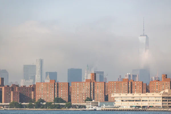 Buildings in New York with skyscrapers hidden by fog