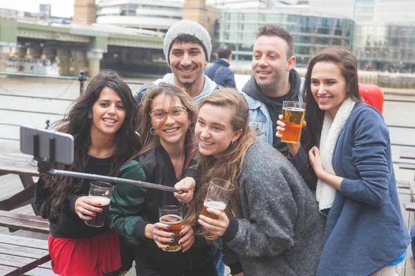 Group of friends taking a selfie at pub in London