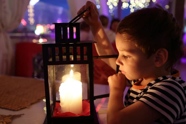 Kid looking at candle