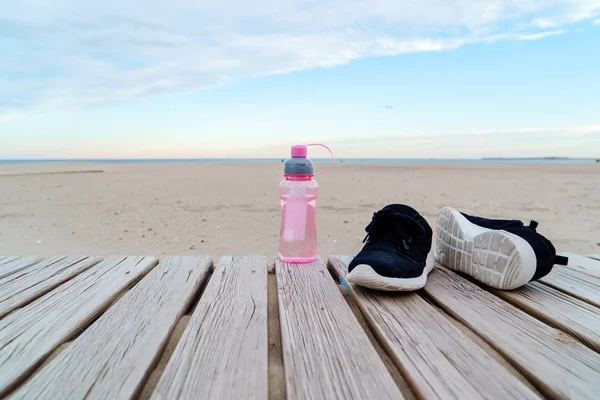Water in bottle and sport shoes