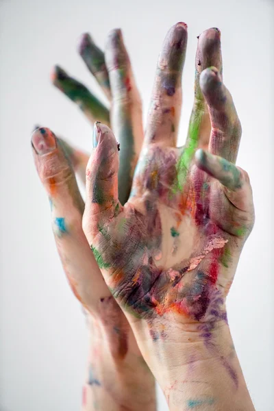Hands of painter in colorful paints