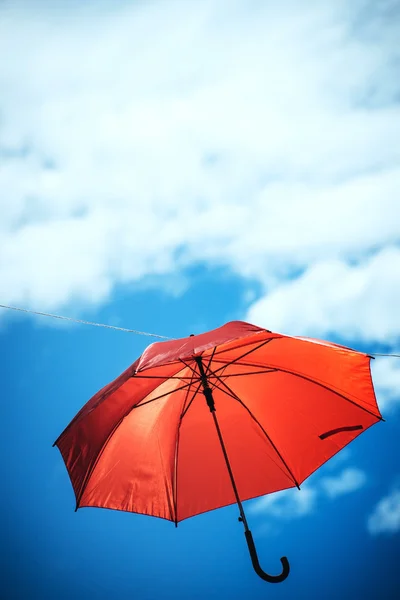 Umbrella against cloudy sky