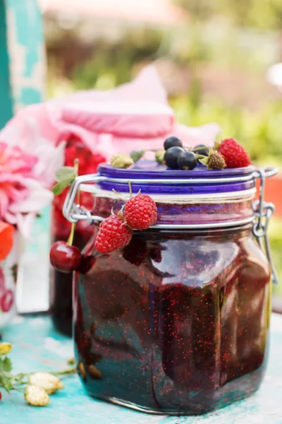 Jar of berry jam with fresh berries