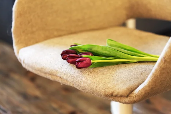 Nice tulips flowers on chair