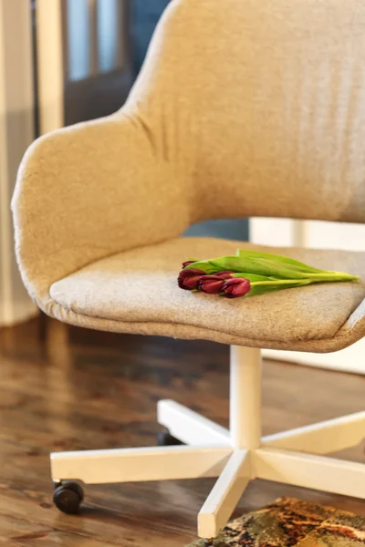 Nice tulips flowers on chair