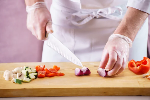 Male chef cutting vegetables