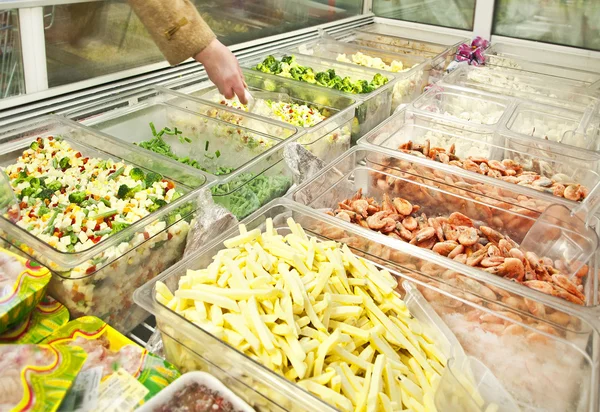 Prepared vegetables and seafoods in shop freezer
