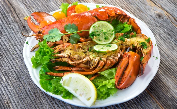 Boiled lobster with vegetables and herbs