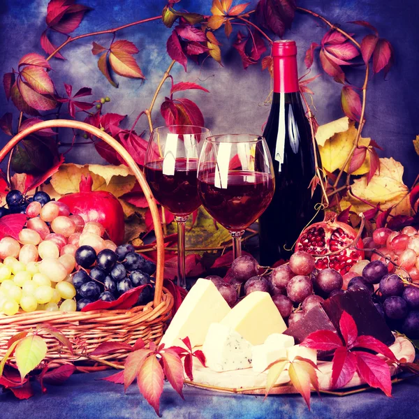 Beautiful still life with wine glasses, grapes, pomegranate and