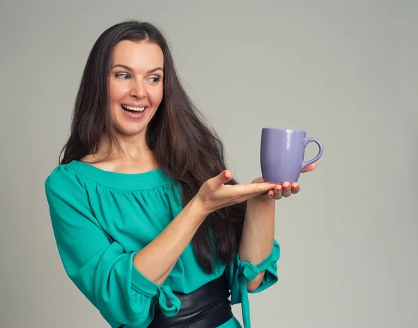 Beautiful woman showing a mug
