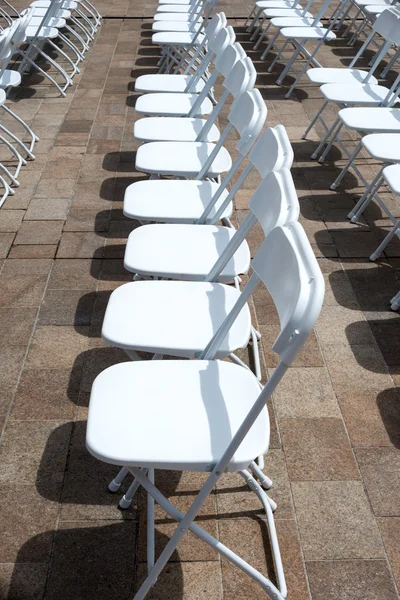 Rows of folding chairs at event